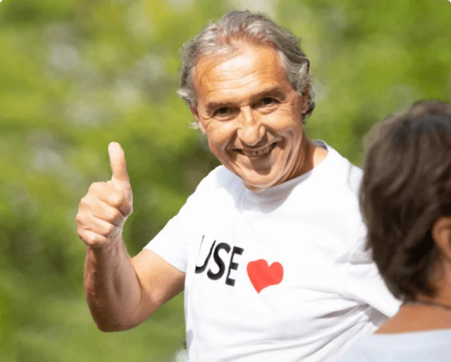 World Heart Day supporter wearing a use heart t-shirt smiling and putting his thumb up