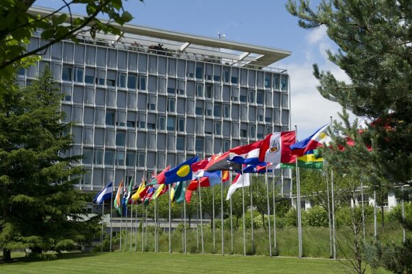 Multiple country flags displayed outside the United Nations headquarters in Geneva, Switzerland