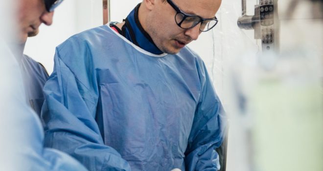 Bojan Stanetic, medical professional performing procedure on patient