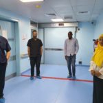 Prof. Ahmed Suleiman stands alongside colleagues in a hospital while social distancing due to COVID-19