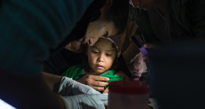 Chagas, a healthcare professional tending to a young child