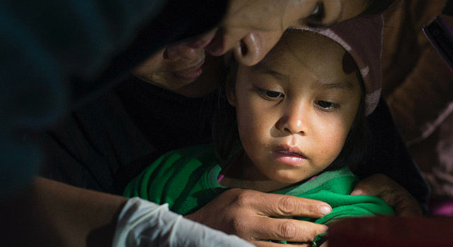 Chagas, a healthcare professional tending to a young child