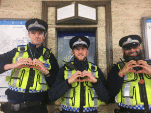 Policemen doing heart hand gestures