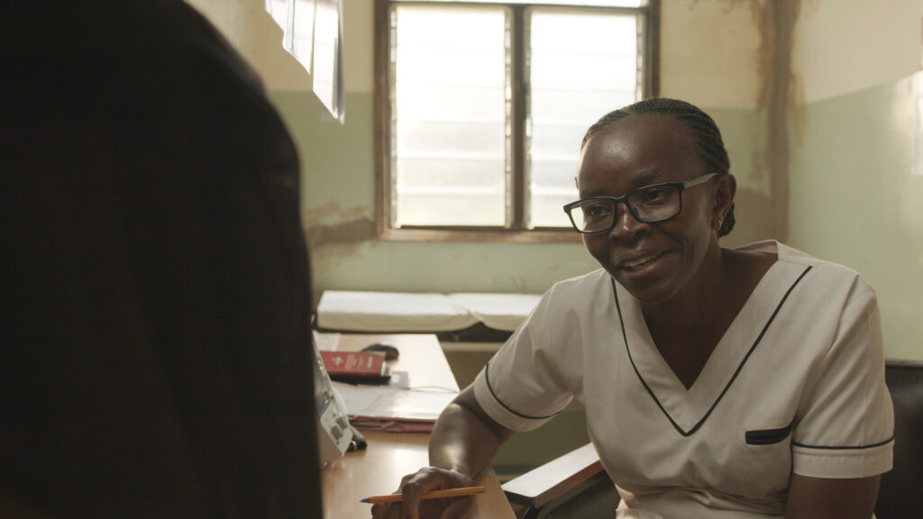 A healthcare professional chatting to a patient