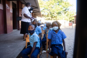 A group of children sat down waiting to be screened for heart disease