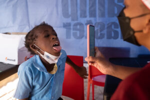 A heart health professional is screening a young child