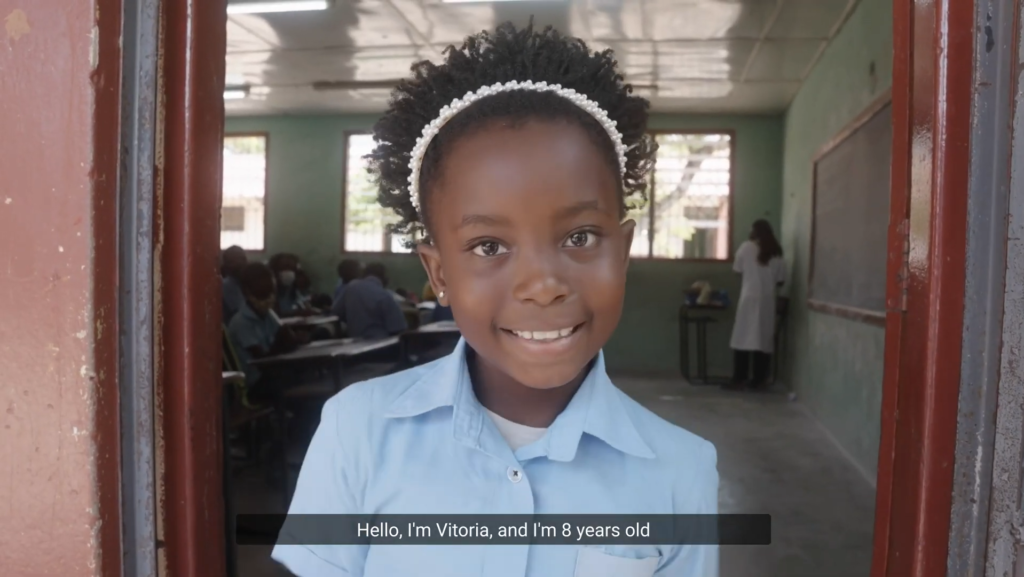 a young girl stood outside a classroom while learning about rheumatic heart disease