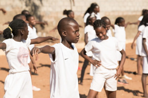 a group of children exercising outside