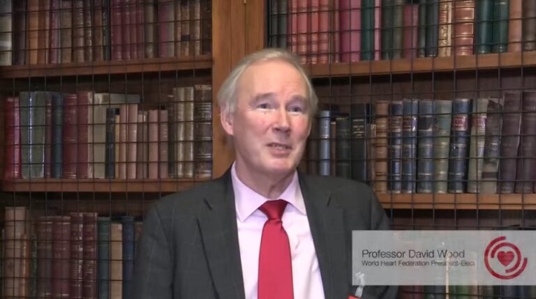 Prof. David Wood being interviewed in front of shelves of books