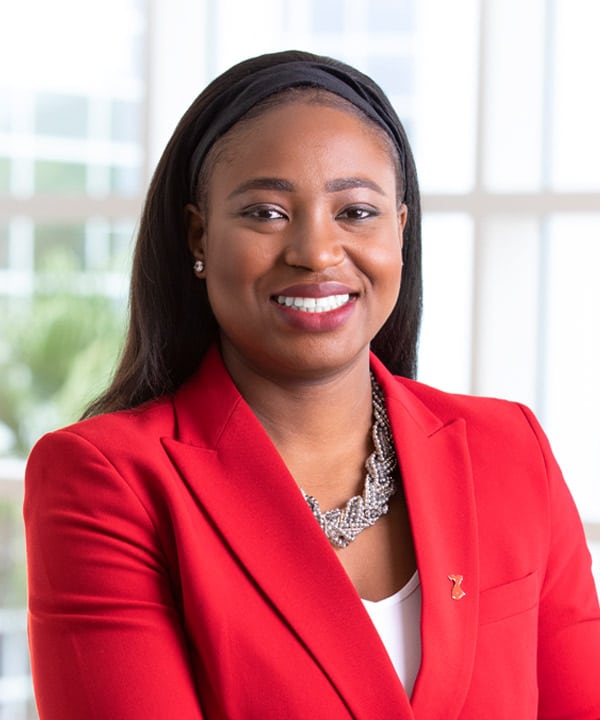 Portrait image of Demilade Adedinsewo in a red blazer