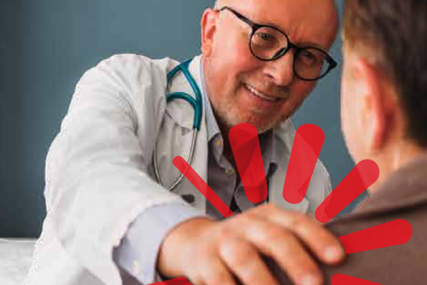 A doctor putting his hand on a patients shoulder in a caring way