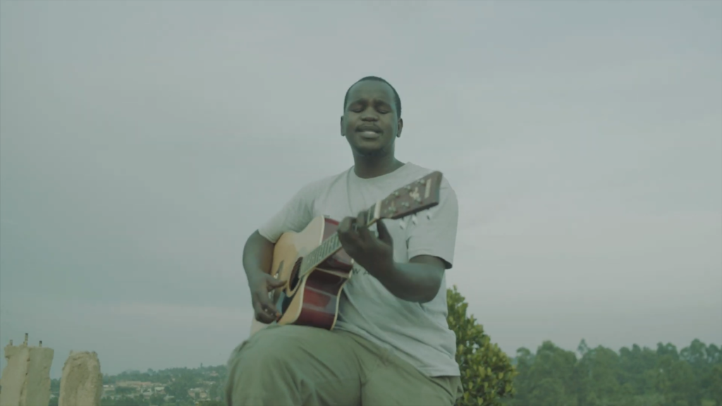 a man in Uganda busking on the streets with a guitar
