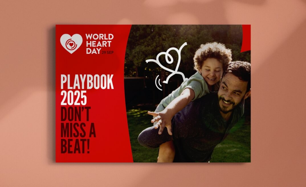 Mockup of the World Heart Day campaign playbook booklet shown on a red background, featuring cover design with heart-themed graphics.