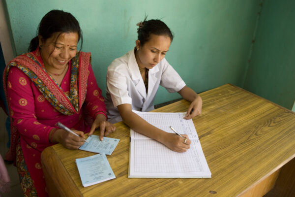 two ladies signing documents