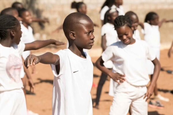 Kids in white clothing moving around