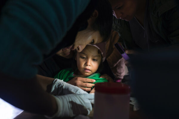 Chagas, a healthcare professional tending to a young child