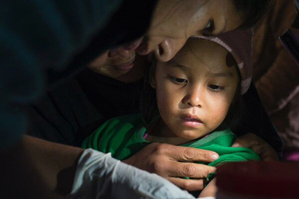 Chagas, a healthcare professional tending to a young child