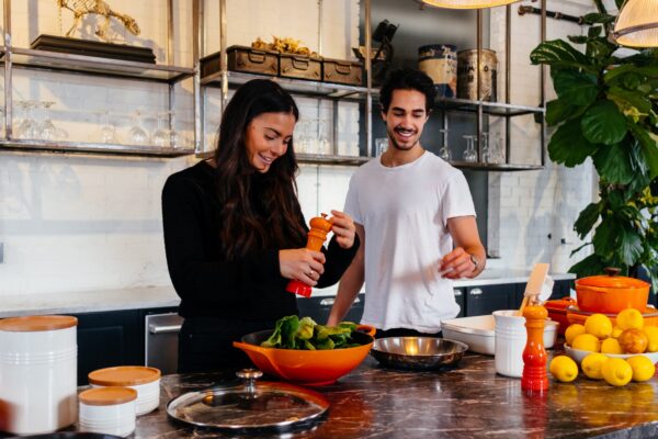 a young couple preparing a healthy meal on an island in the kitchen
