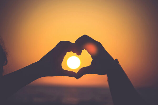 Heart Hands around a sunset