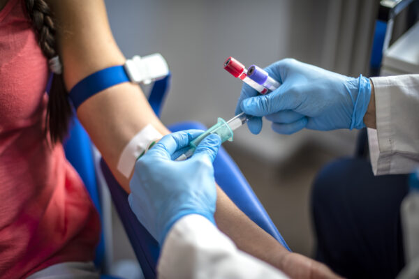 A patient having their bloods taken from a medical professional