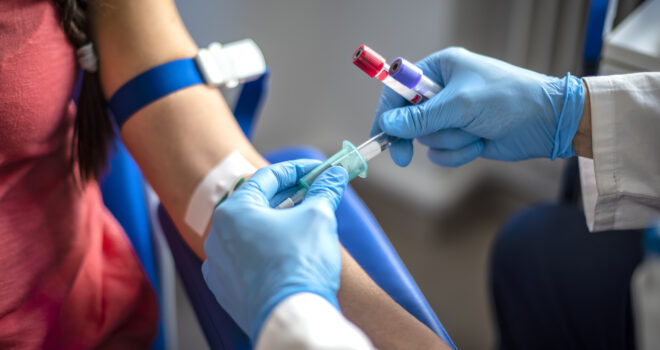 A patient having their bloods taken from a medical professional