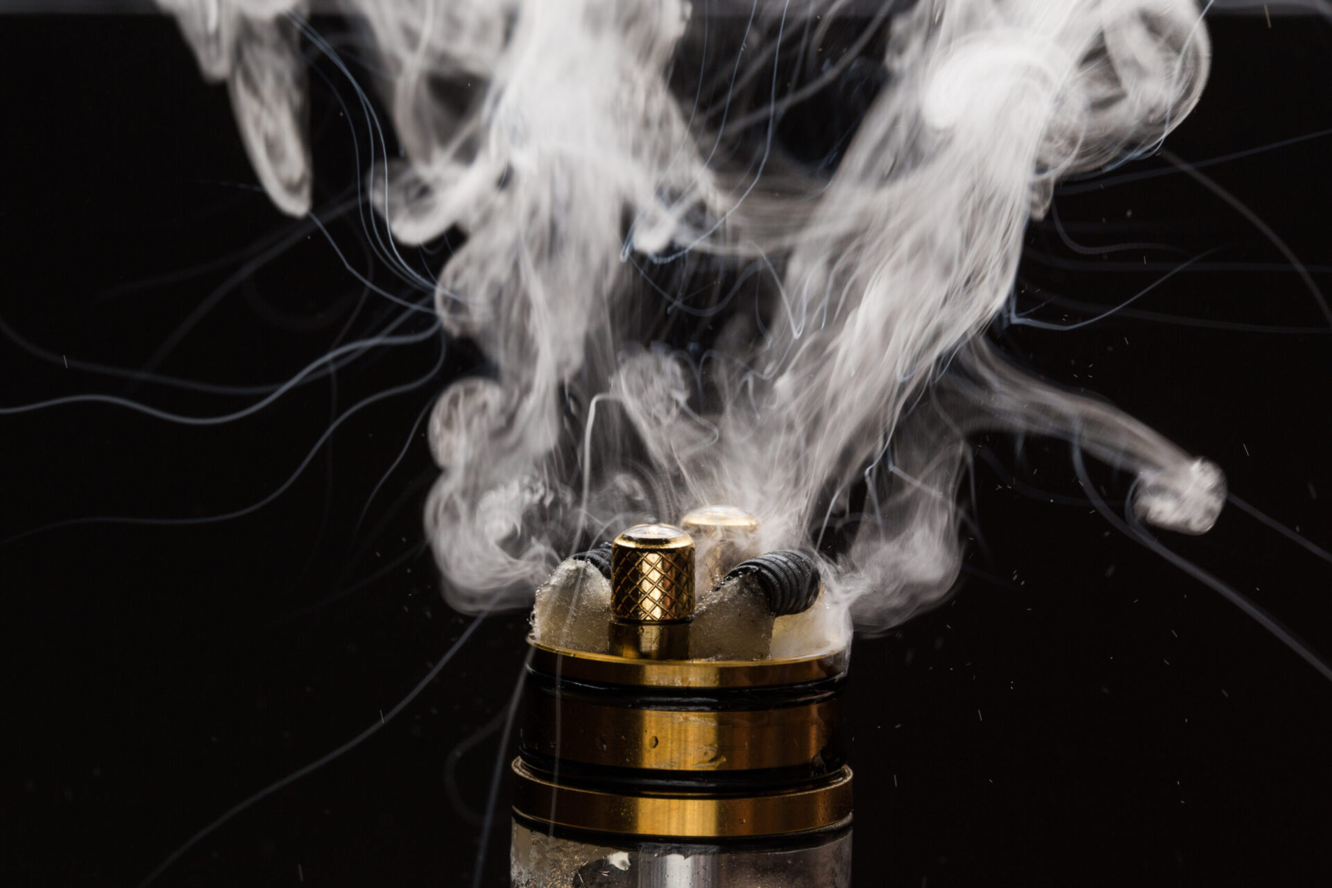 Vape close-up with vapour on a black background