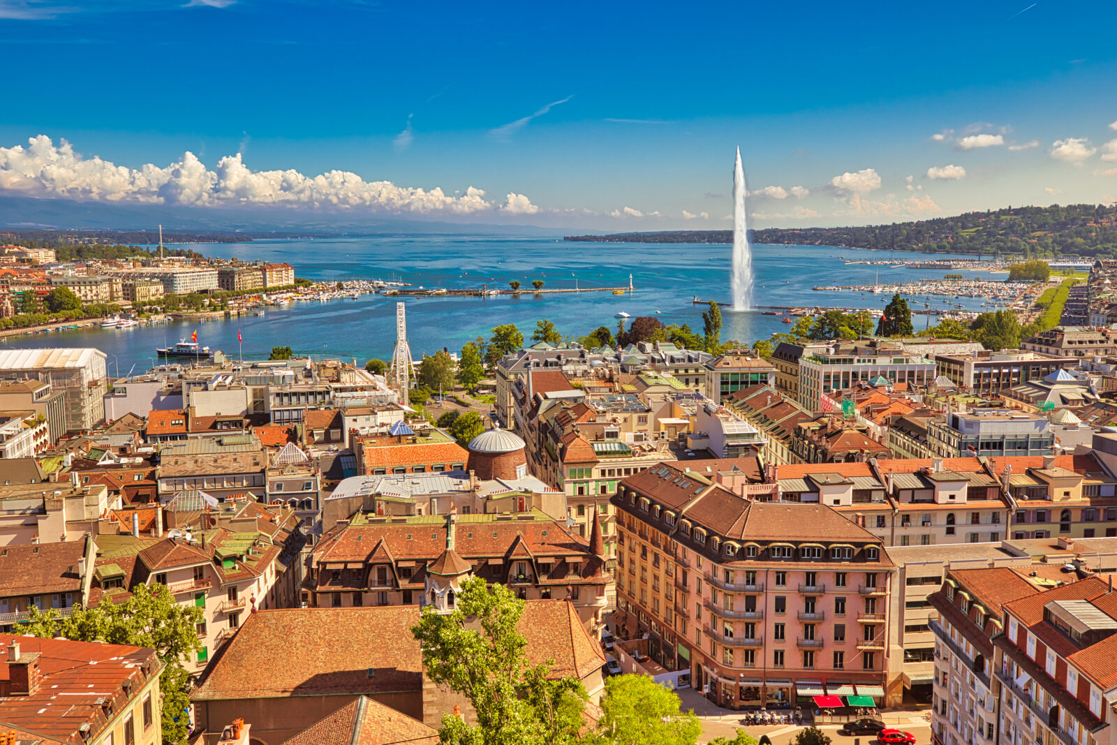 An aerial view of Geneva, Switzerland with Jet d'eau fountain and lake geneva in the foreground
