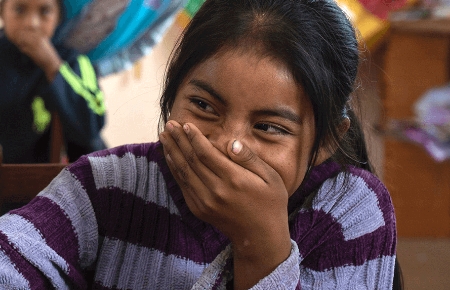 A child covering their face