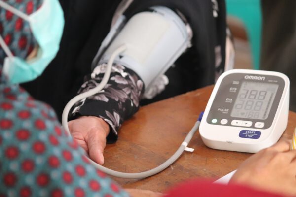 lady using blood pressure monitor