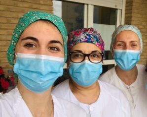 Three nurses wearing Personal Protective Equipment (PPE) during COVID-19 global pandemic