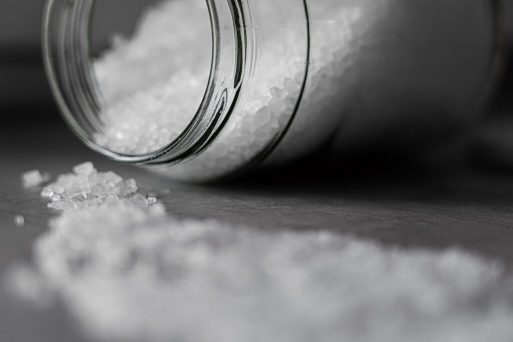 Jar of salt on its side with the salt spilled out - heart health