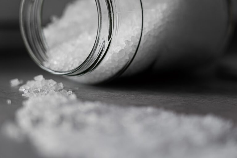 Jar of salt on its side with the salt spilled out - heart health
