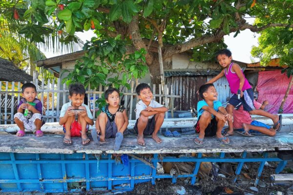 Young children playing and sitting on the streets