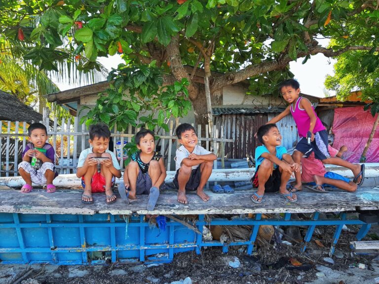 Young children playing and sitting on the streets