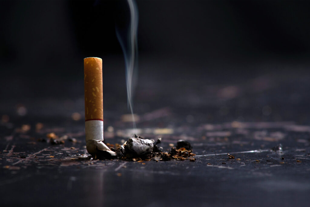 A photo of a cigarette squashed against the ground