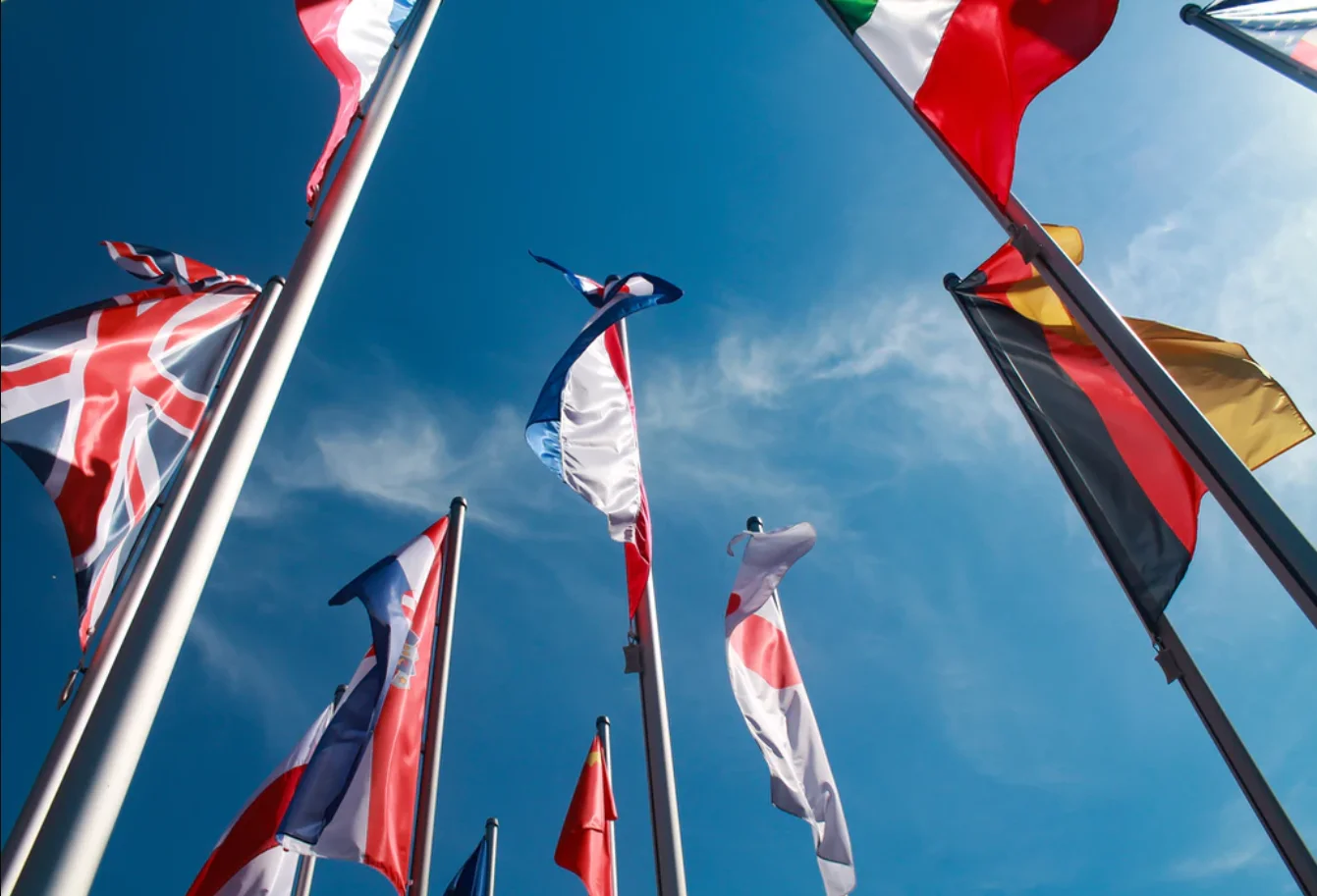 WHO headquarters in Geneva, Switzerland surrounded by flagpoles displaying the national flags of member countries.
