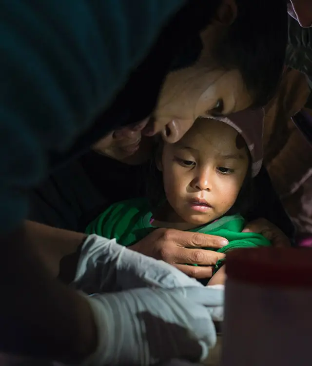 Chagas, a healthcare professional tending to a young child