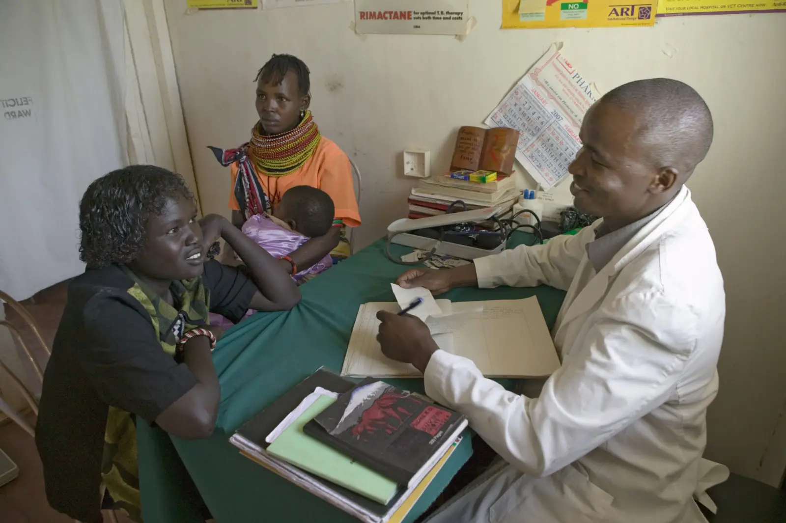 A doctor consults with mother and children