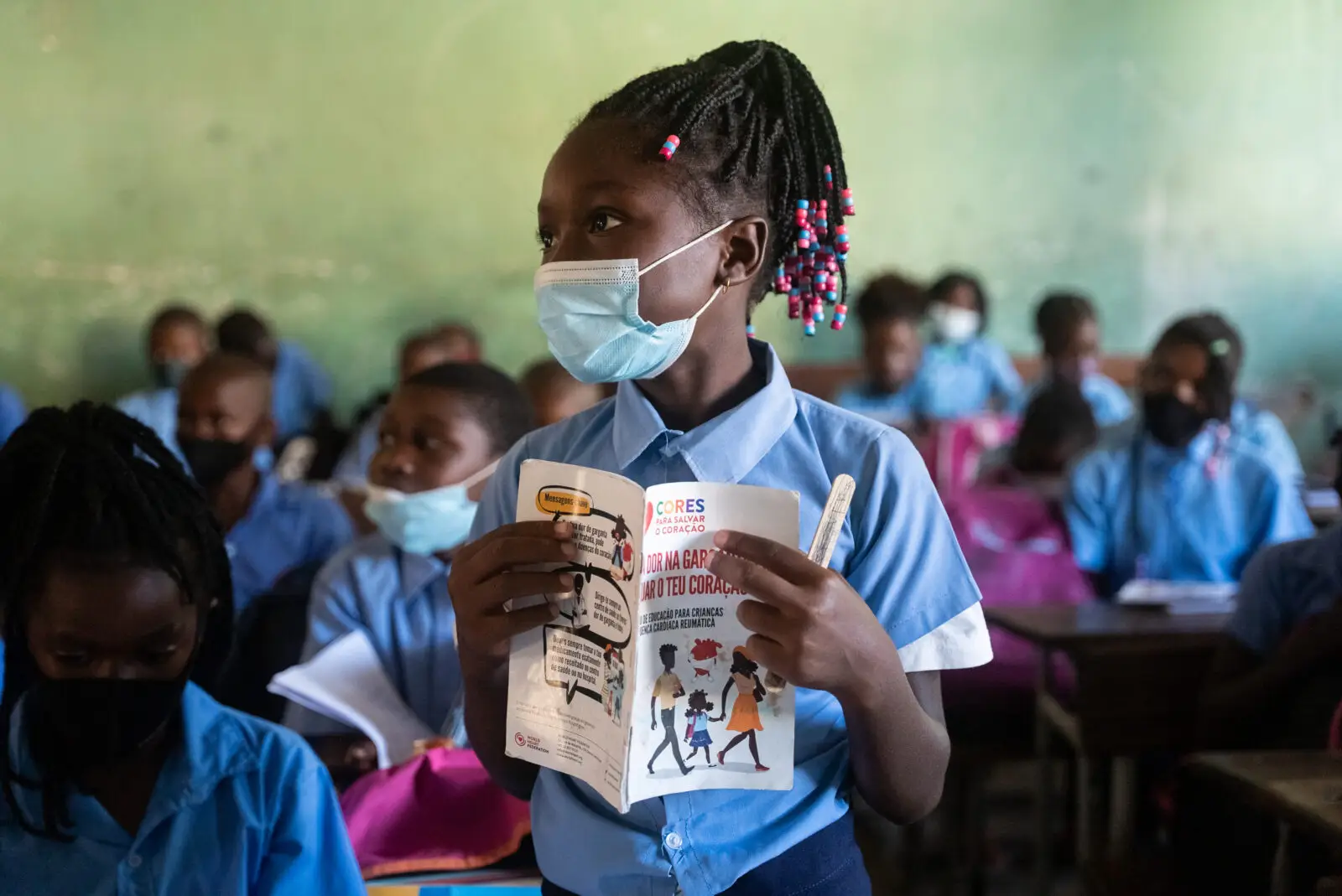 a young girl from Mozambique stood in a classroom while learning about rheumatic heart disease