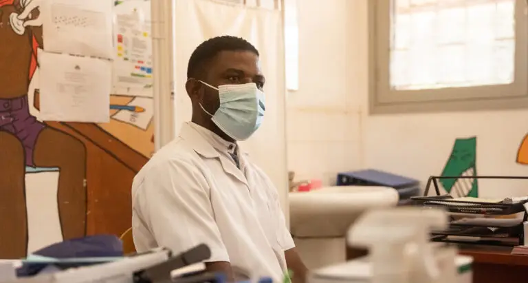 a medical professional wearing a face mask in an office