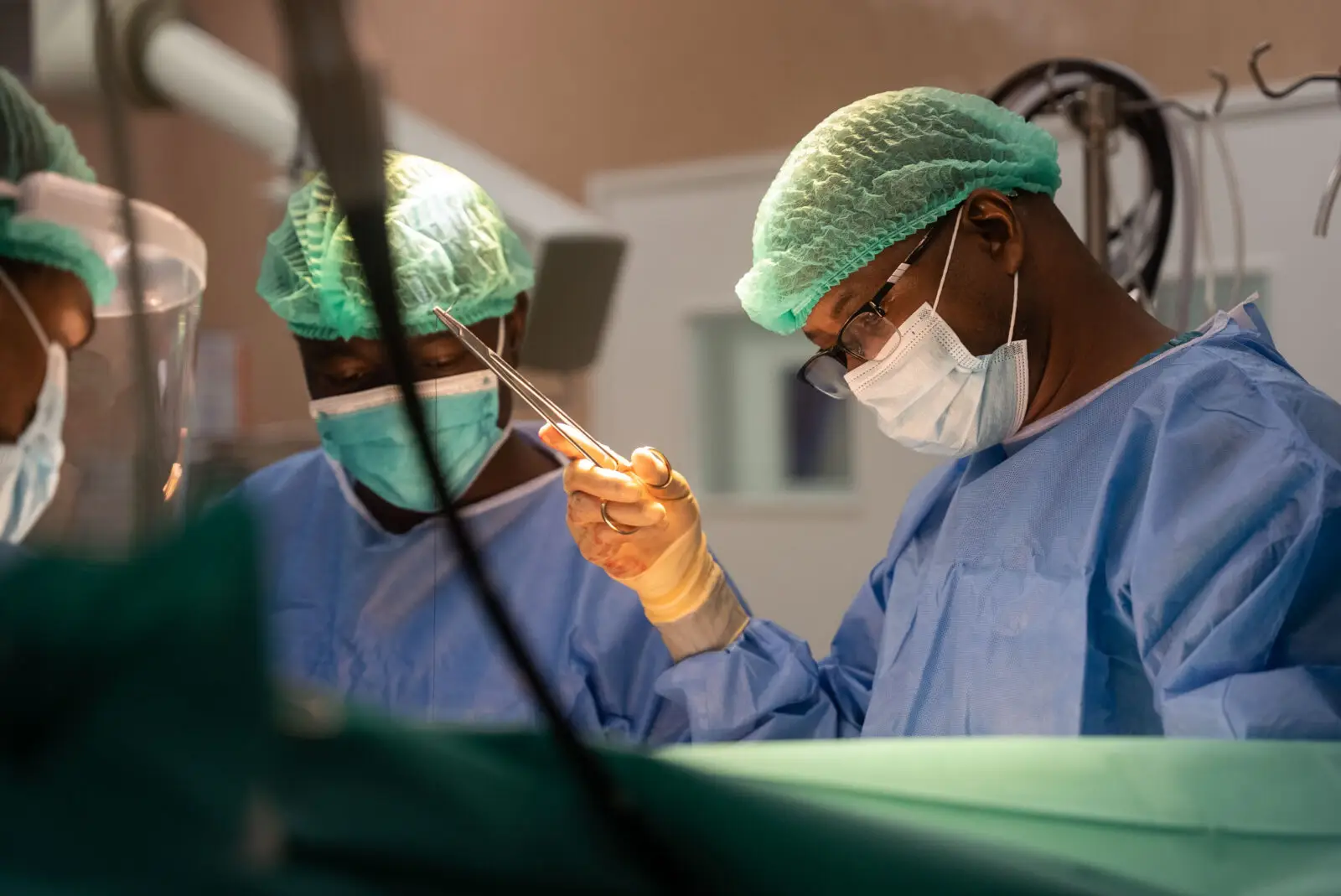 Surgeons operating on a patient for open heart surgery