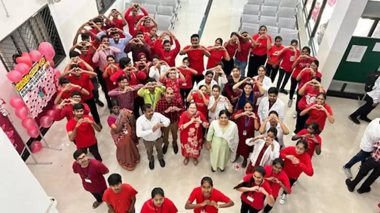 A birds eye view of staff gathered together to form the shape of a heart