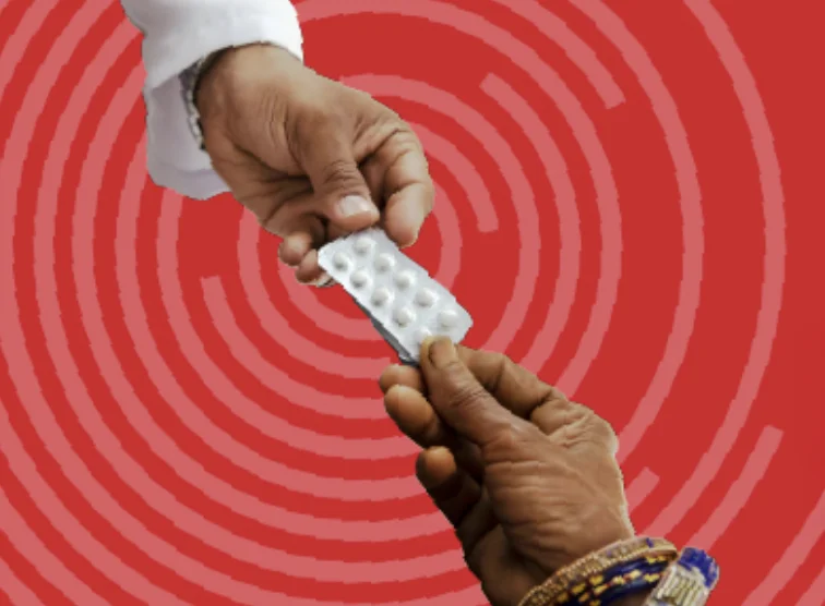 A photo of a packet of pills being passed between two people
