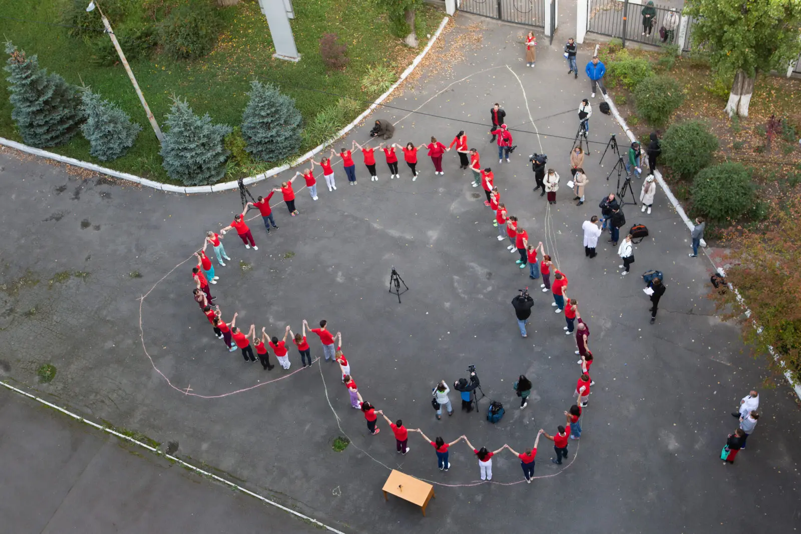 Drone captures a group of World Heart Day supporters posing in the shape of a heart
