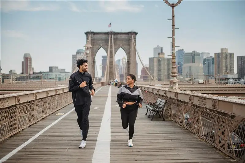 Advocating for Physical Activity and Healthy Cities in the Eastern Mediterranean Region - 2 runners crossing a bridge in a city area