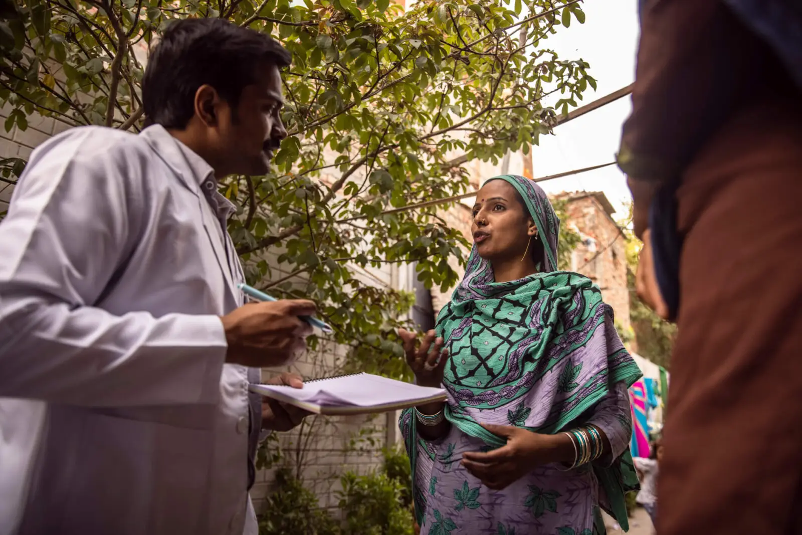 a doctor in India speaking with a female patient on the street